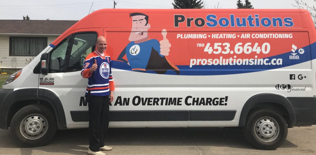 ProSolutions Inc. owner Jason Billey stand beside one of the company installation trucks